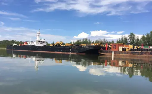 An NTCL barge and tug on the Mackenzie River. Image by Brian Castner. Canada's Northwest Territories, 2016.