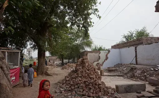 A child watches as a row of shops is demolished by authorities for collective punishment in Khyber Agency, in the Federally Administered Tribal Areas. Image by Umar Farooq. Pakistan, 2017.