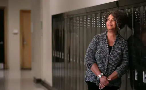 Judy Gladney, 67, poses for a portrait at University City High School. Gladney was among the first African-American students to integrate the high school. Image by Cristina M. Fletes. United States, 2019.