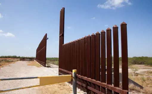 A section of the border wall stretches through the Rio Grande Valley sector of the Texas border on Aug. 20, 2019. Image by Jinitzail Hernández. United States, 2019.