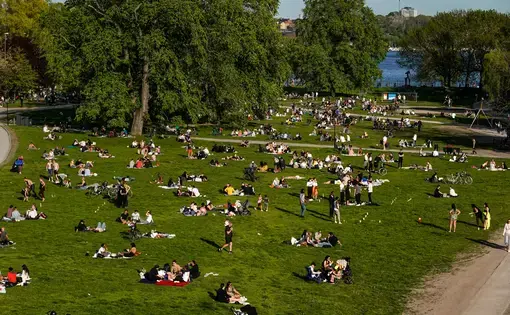 People in Stockholm's Ralambshovspark on a summer day during the coronavirus pandemic. Image by Alexanderstock23 / Shutterstock. Sweden, 2020.