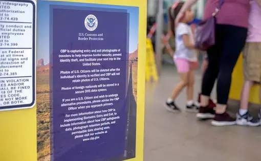 A sign explains how photos of border crossers are being used. Image by Kathleen Flynn. United States, 2019.