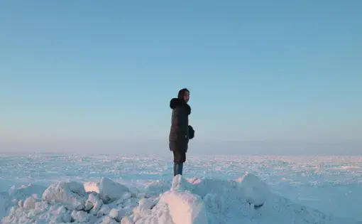 Coffee &amp; Quaq podcast host Alice Qannik Glenn overlooks the frozen Arctic Ocean in February. Image by Jenna Kunze. United States, 2020.