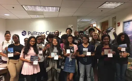 DC Study Abroad Contest finalists stand with their photographs at a reception on September 26, 2017. All contest finalists received framed prints of their winning photographs and captions. Image by Fareed Mostoufi. United States, 2017.