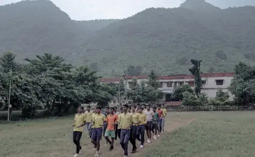 Marching practice on the school playground after the end of classes. Image by Arko Datto. India, 2018.