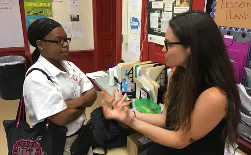 Natalie Keyssar talks to a student at North Lawndale College Prep