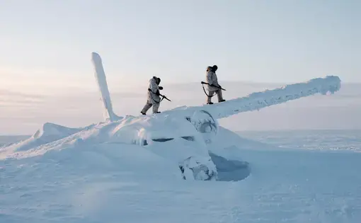 Canadian Arctic operations advisers scale the decades-old wreckage of an airplane in temperatures below -50C. They are on reconnaissance outside Resolute Bay on Cornwallis Island, Nunavut, Canada. Image by Louie Palu / Zuma Press. Canada, undated.