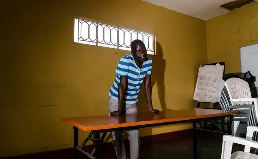 Leticia Opio, an out transgender woman and founder of the LGBT advocacy group Queer Youth Uganda, poses for a portrait at the QYU offices. On the morning of Christmas Eve 2016, someone broke into Opio's home and attacked her from behind, slamming her head into the wall until she was unconscious. In the intervening weeks, she has suffered from memory loss, nightmares and general anxiety. Image by Jake Naughton. Uganda, 2017.
