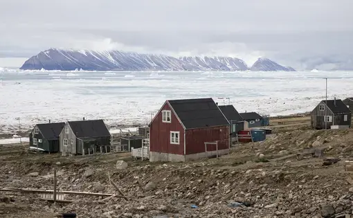 Many of the residents in Qaanaaq live in permafrost areas, and their homes are built on frozen ground. As the permafrost thaws, the ground becomes weaker and less able to support these structures, and it becomes dangerous to live inside. In parts of North Greenland, coastlines and soil are being eroded as storms batter the land and the permafrost crumbles. Image by Anna Filipova. Greenland, 2018.