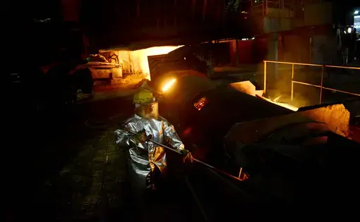 A Tata Steel worker checks the temperature of the one of the plant's seven blast furnaces during an afternoon. Image by Michael Henninger. India, 2016.