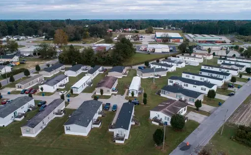Abbott Park, a mobile home park in Lumberton, N.C., pictured here on Friday, Oct. 16, 2020, is owned by Time Out Communities. According to an Associated Press report, the company bought almost all of the mobile home parks in Lumberton after Hurricane Florence. Researchers examining the health effects of rising temperatures in counties like Robeson, which is located in the Sandhills region of the state, are looking at how higher temperatures can impact residents of mobile home parks and exacerbate social…