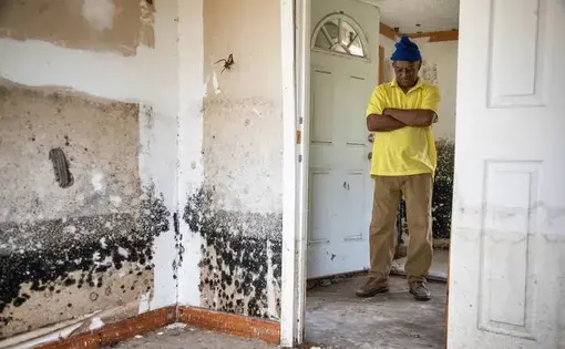 Sellers, South Carolina Mayor Barbara Hopkins shows homes damaged by repeated flooding and hurricanes on February 13, 2020. While many homeowners across the small town have received help from FEMA and other natural disaster response agencies, those without a clear title for their home have been left with no government help in mold saturated homes. Image by Joshua Boucher. United States, 2020.