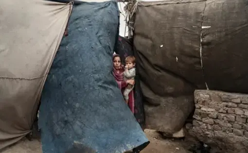 Children living in an encampment, in Jalalabad, after fleeing violence between isis and the Taliban. There are now two and a half million internally displaced Afghans. Image by Adam Ferguson. Afghanistan, 2019.