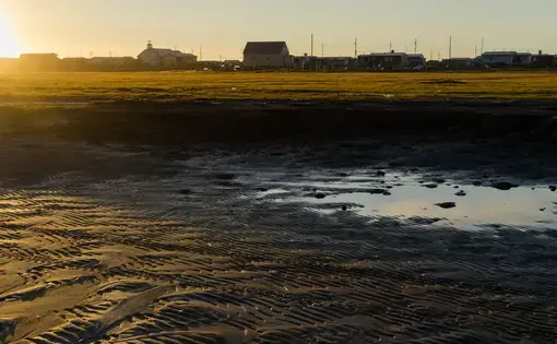 Brent Iyatunguk walks on the inland beach of the town of Shishmaref. Image courtesy of Nick Mott. United States, 2018.