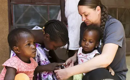 A U.S. military member interacts with orphans at Saint Vincent Orphanage of Niamey during Flintlock 2018 in Niamey, Niger. U.S. Army photo by Sgt. Heather Doppke/79th Theater Sustainment Command. Nigeria, 2018.