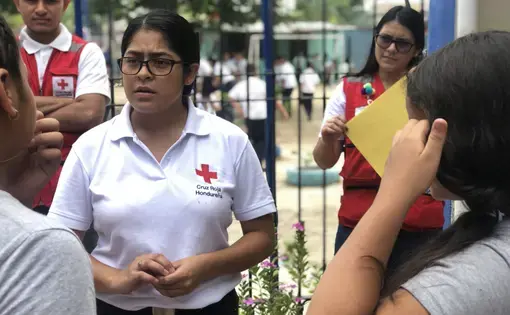 The Honduran Red Cross helps kids affected by migration. Here, Karen Martinez talks with a student. Image by Jaime Joyce. Honduras, 2019. The Honduran Red Cross helps kids affected by migration. Here, Karen Martinez talks with a student. Image by Jaime Joyce. Honduras, 2019.