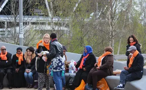 Before the rally, Migrants Organise, an organization that helps immigrants in all kinds of circumstances in London, had a picnic with food, music and dancing—sharing a message of welcome for all migrants in Olympic Park. Image by Abe Kenmore. United Kingdom, 2016.