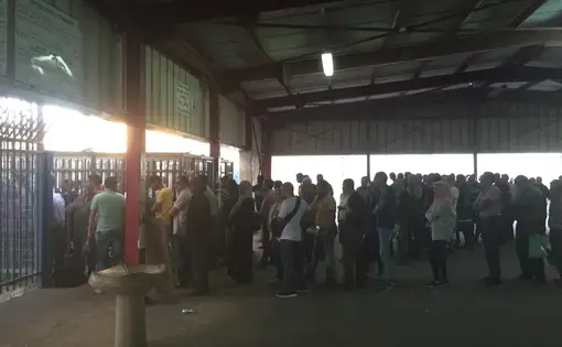 Palestinians line up at Qalandia checkpoint in Palestine to get through security and into Israel for a day's work. Image by Matt Kennard. Palestine, 2016.