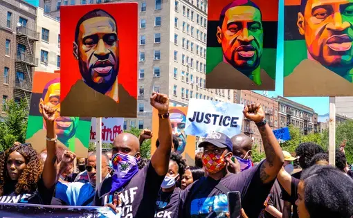 Marchers raise their fists at a justice rally for George Floyd and celebration of Juneteenth. Image by Fiora Watts / Shutterstock. United States, 2020.