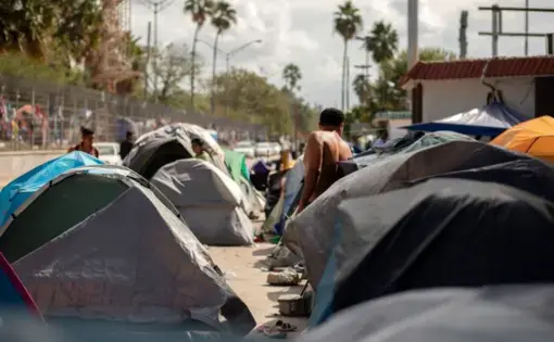Rows of tents are clustered near the Gateway International Bridge in Matamoros, Mexico. Image by Miguel Gutierrez Jr. Mexico, 2019.