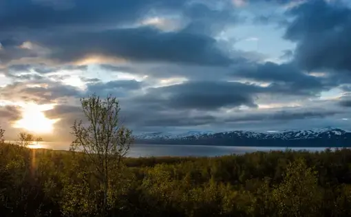 The sun sets over the water near Abisko, Sweden. Image by Amy Martin. Sweden, 2018.
