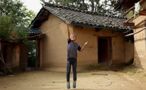 Eight-year-old Wang Jie plays in the courtyard of his family's farmhouse in Liangshan prefecture, Sichuan province. Image by Max Duncan. China, 2016.  