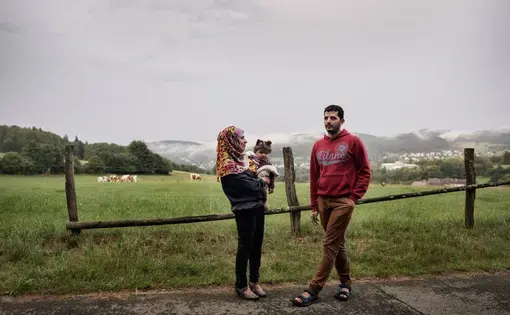 Nour Altallaa, her husband Yousef Alarsan and their daughter Rahaf explore their new home in a camp near Bad Berleburg, Germany, on July 19. Image by Lynsey Addario. Germany, 2017.