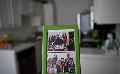 Photos of the Flores family from the past are seen in their Chula Vista kitchen. Image by Amanda Cowan. United States, 2019.