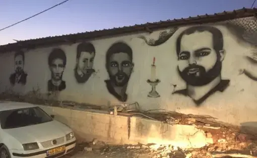 Murals of Palestinians killed by Israel decorate the walls around Qalandia village near the checkpoint. Image by Matt Kennard. West Bank, 2016.