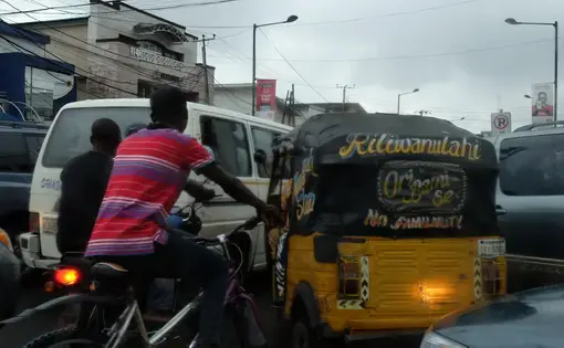 A three-wheeled keki tries to burrow its way through the Lagosian traffic. Image by T.R. Goldman. Nigeria, 2017.