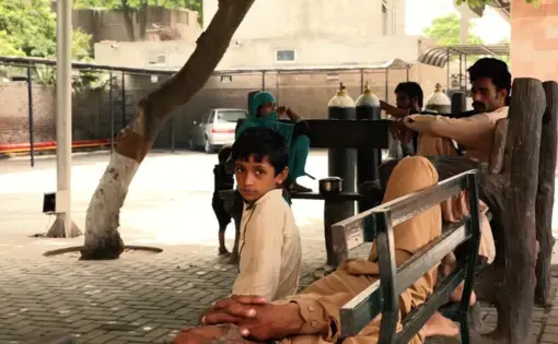 A child sits&nbsp;outside an Ahmadi-funded hospital that provides free healthcare to patients. Image by Isabella Palma Lopez. Pakistan, 2018.