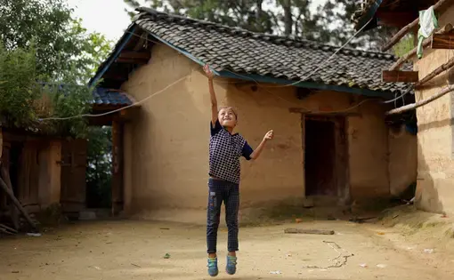 Eight-year-old Wang Jie plays in the courtyard of his family's farmhouse in Liangshan prefecture, Sichuan province. Image by Max Duncan. China, 2016. 
