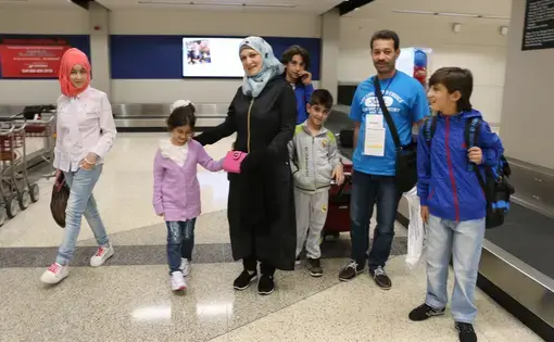Ghazweh Aljabooli and her husband and five children arrive in the Des Moines airport just before midnight one night in June 2016.