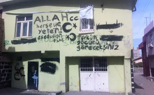 A graffiti-daubed house in the old walled city, in Diyarbakir, the main city in the Kurdish-majority southeast of Turkey. The graffiti says, 'you will see the strength of the Turk,' as well as exhortations to God, and was left by Turkish soldiers who recently fought running battles with Kurdish nationalists who had declared the walled city an autonomous zone. Image by Christopher de Bellaigue. Turkey, 2015.