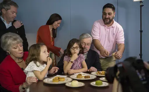 The Branstad family is filmed while eating mooncakes for a Mid-Autumn Festival video greeting filmed by members of the U.S. Embassy staff on Sunday, Sept. 24, 2017, at the ambassador's residence in Beijing, China. Mooncakes are traditionally eaten to celebrate the holiday, which fell on Oct. 4 this year. Image by Kelsey Kremer. China, 2017.