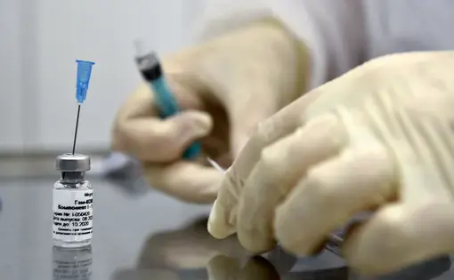A nurse prepares to inoculate volunteer Ilya Dubrovin, 36, with Russia's new coronavirus vaccine in a post-registration trials at a clinic in Moscow on September 10, 2020. Russia announced last month that its vaccine, named "Sputnik V" after the Soviet-era satellite that was the first launched into space in 1957, had already received approval. The vaccine was developed by the Gamaleya research institute in Moscow in coordination with the Russian Defence Ministry. Image by Natalia Kolesnikova/AFP. Russia,…