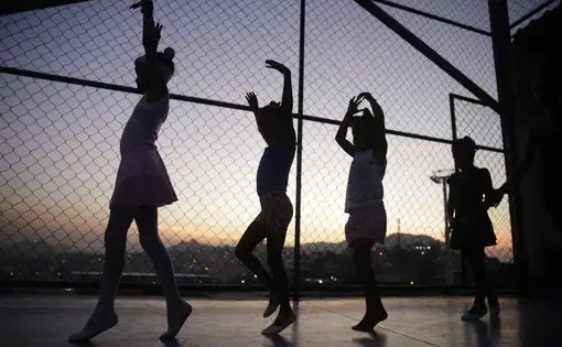 Young ballerinas rehearse at an outdoor sports court in the Morro do Adeus favela, Rio de Janeiro. Image by Frederick Bernas. Brazil, 2018.