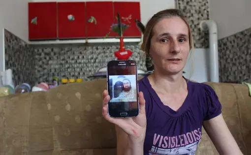 Alema Dolamić shows a photo of her sister in Roj Camp. Image courtesy of&nbsp;Asim Bešlija. Bosnia, 2018.