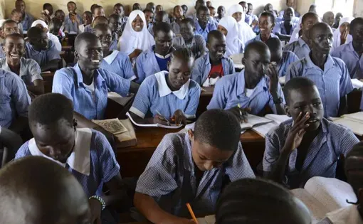 In Kakuma, it is common for students of many ages to learn together in a single classroom. Image by Rodger Bosch for UNICEF USA. Kenya, 2018.