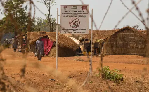 A sign at the entrance to the camp in Bria warns against bringing in weapons. Image by Jack Losh. Central African Republic, 2018.