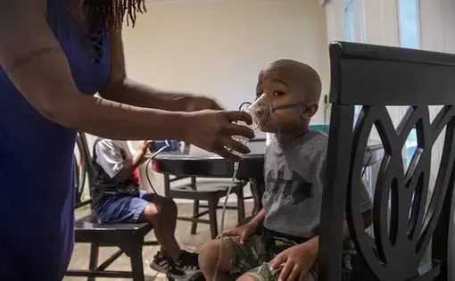 Four-year-old Jeremiah Galbreath receives a nebulizer treatment for asthma at his home in Bayboro. Image by Travis Long / The News &amp; Observer. United States, 2020.