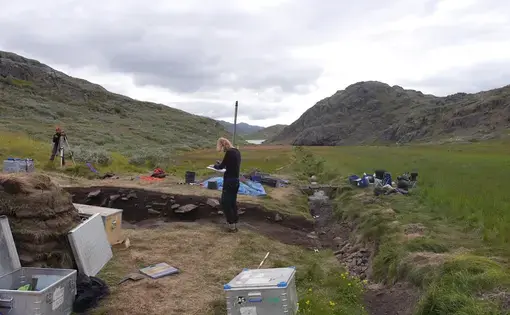 Archeologist Elie Pinta takes height measurements at an archeological dig in southern Greenland. The excavation, at a place, known today at Tasilikulooq, focuses on a site that once housed a small Norse dairy farm. Image by Eli Kintisch. Greenland, 2016.
