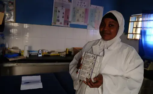 Fatima Yakubu, a Nigerian community health extension worker, holds tubes of chlorhexidine digluconate 7.1 percent gel. Yakubu’s rural primary health care facility is one of about 120 clinics in the central Nigerian state of Kogi that are supported by USAID’s Maternal and Child Survival Program. Image by T.R. Goldman. Nigeria, 2017.