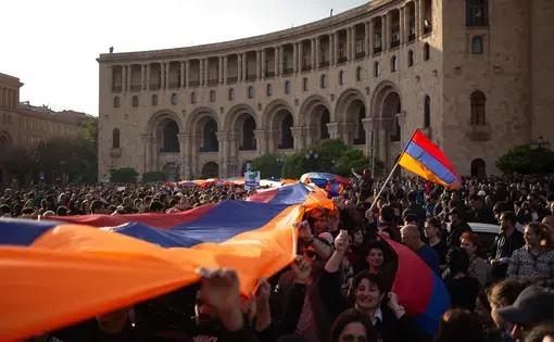 Protesters holding an Armenian flag on Yerevan's Republic Square during a rally in 2018. Image by Kacper Kawecki / Shutterstock. Armenia, 2018.