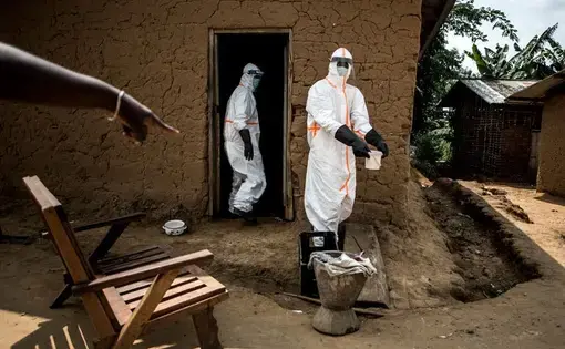 Ebola responders disinfect a home in Aloya in which three people have died. Image by John Wessels. Democratic Republic of Congo, 2019.