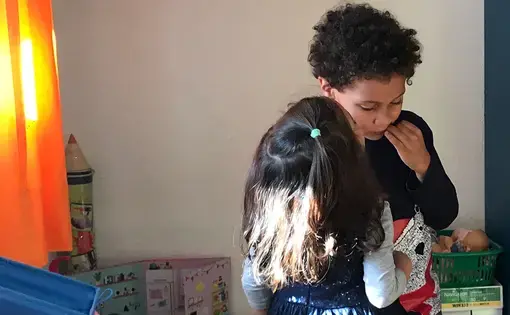 The author's 5-year-old son gets a kiss on the cheek from a kindergarten classmate on his last day of school in Morocco before returning to the United States in November. Image by Jackie Spinner. Morocco, 2017.