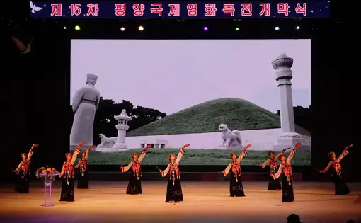 Women dressed in traditional Korean dresses performing at the opening ceremony of the 15th Pyongyang International Film Festival. Image by Laya Maheshwari. North Korea, 2016.