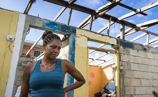 Rosalda Olma, a wife and mother to three kids, sorts through what remains of her home in Loiza. The entire home and contents were destroyed by the hurricane, and the family is living in a nearby school for the time being. “It’s hard getting used to these living conditions,” she said. “All five of us are trying to fit inside a single room.” Image by Ryan Michalesko. Puerto Rico, 2017.