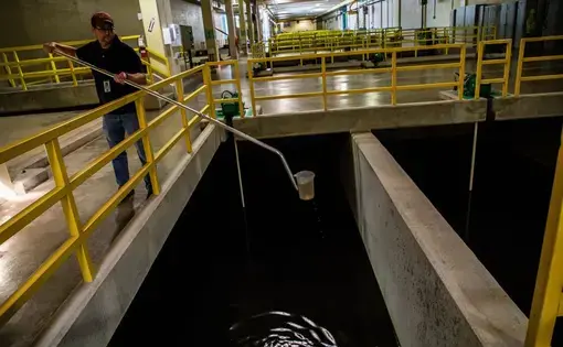Assistant plant manager Brian Thompson takes a water sample from a section of the Morgan Water Treatment Plant in Cleveland on Sept. 26, 2019. Image by Zbigniew Bzdak. United States, 2019.
