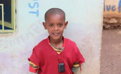 Natie Asnaunew poses for a photo at the day care center in Gondar Ethiopia. This day care center is run by Yenege Tesfa, Hope for Tomorrow, and it allows single mothers to drop their kids of everyday so they are able to go to work and help provide for their family. Image by Abigail Bekele. Ethiopia, 2018